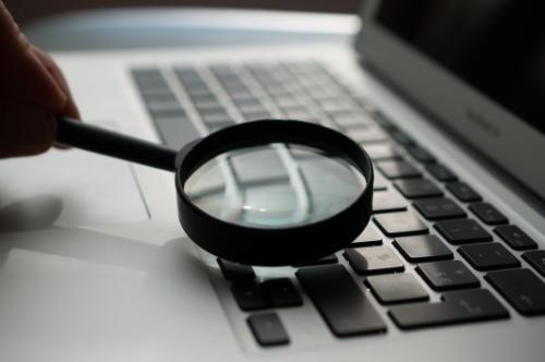 Magnifying glass on laptop keyboard